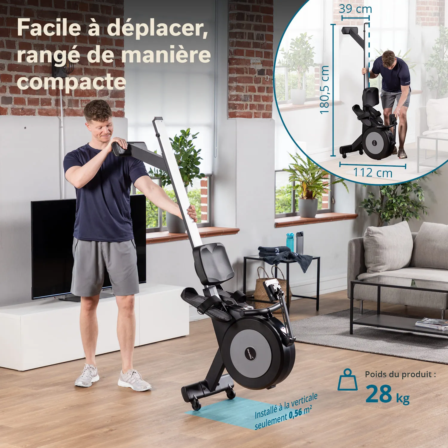 Fahrrad-Ergometer wird von einer Person in einem Wohnraum mit Fenstern und Pflanzen aufgestellt. Couch und Fernseher sichtbar.