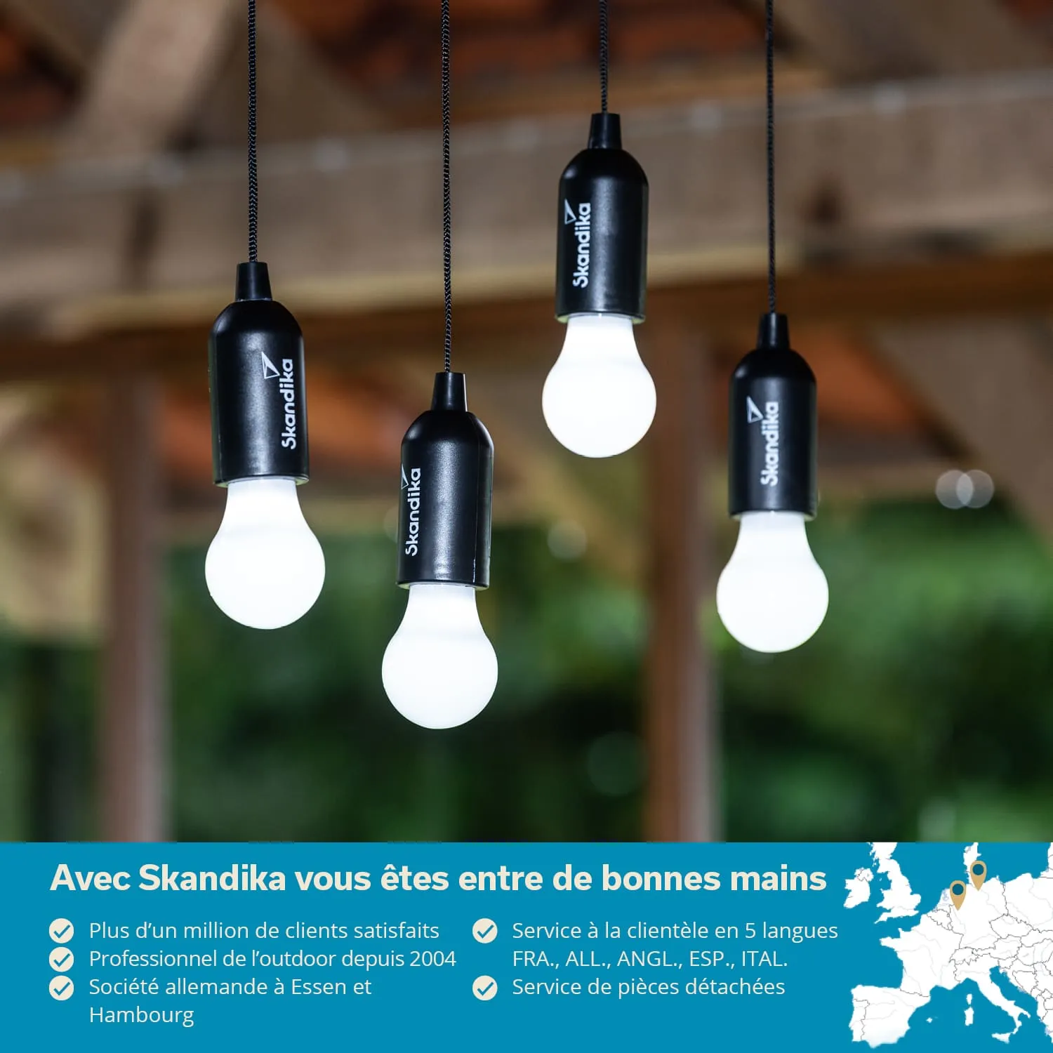 Hängende LED-Lampen mit schwarzen Fassungen, im Hintergrund unscharfer grüner Wald und ein blauer Untergrund mit Text.