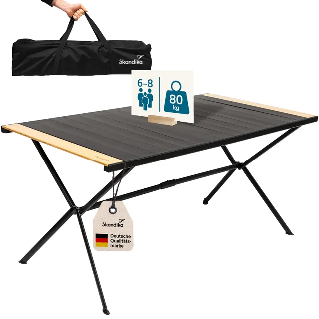 Faltbarer Tisch mit schwarzer Oberfläche und Holzleisten. Inklusive Tragetasche und Hinweisschild zu Gewicht und Personenanzahl.