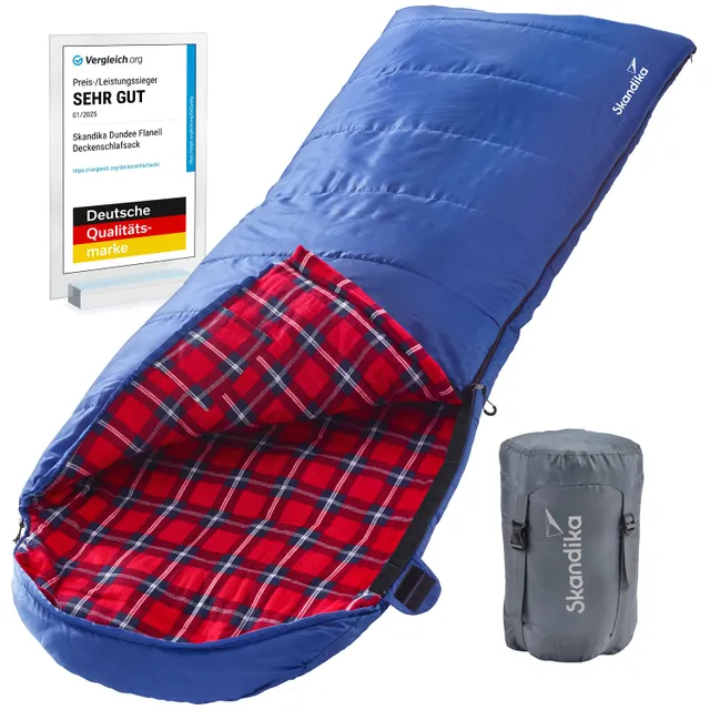 Blauer Schlafsack mit rotem, kariertem Innenfutter und einem grauen Packsack daneben. Ein Preis- und Qualitätssiegel im Hintergrund.