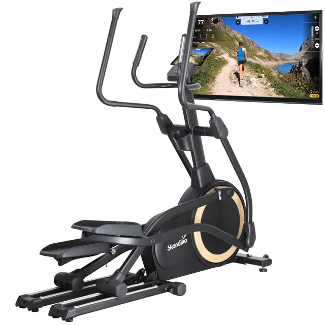 Ellipsentrainer mit schwarzen Pedalen und Rahmen, ausgestattet mit einem Bildschirm, der eine Landschaft zeigt.